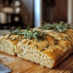 Rosemary sourdough bread with a rustic golden crust, fresh rosemary on top
