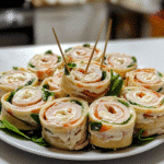Close-up of turkey cheese pinwheels showing spiral layers on a plate