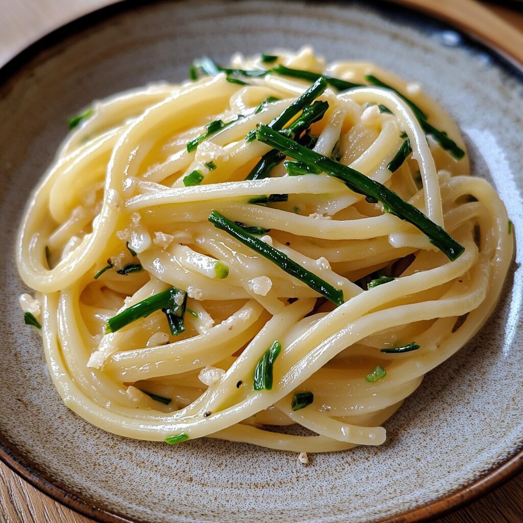 Garlic Scape Pasta served on a plate in natural light